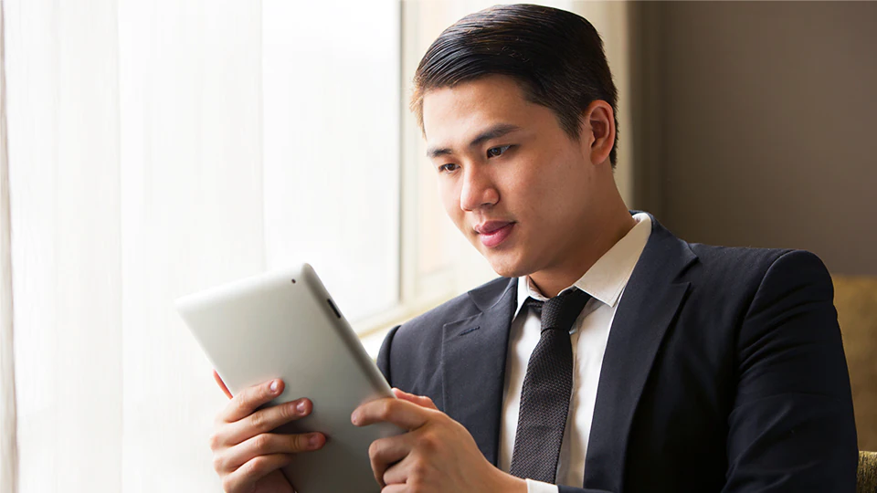 Businessman looking at tablet to track shipment